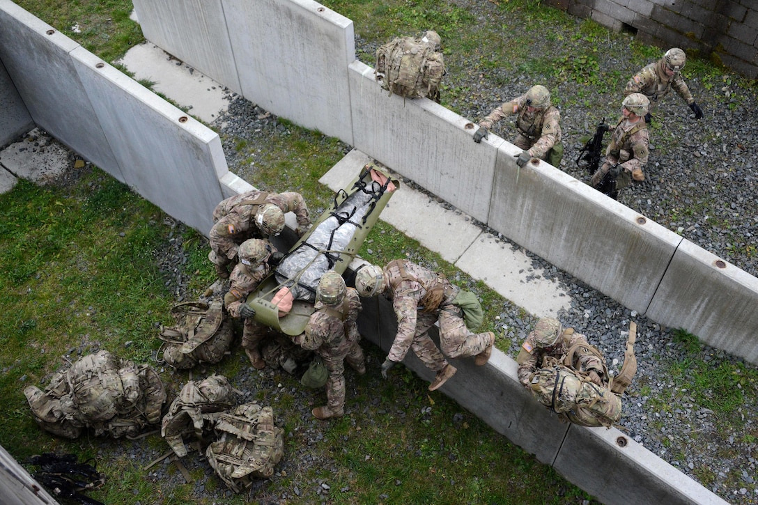 U.S. soldiers conduct the urban casualty evacuation lane during the European Best Squad Competition at the Grafenwoehr Training Area in Bavaria, Germany, Oct. 20, 2015. The soldiers are assigned to the 3rd Infantry Division’s 1st Armored Brigade Combat Team. U.S. Army photo by Gertrud Zach    