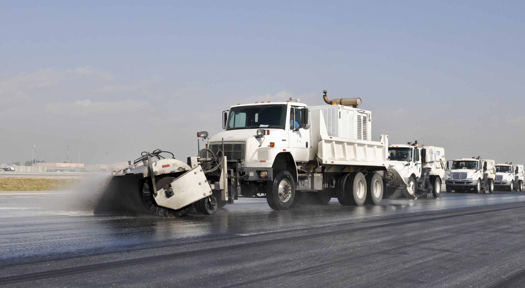 Airmen from the 577th Expeditionary Prime Base Engineer Emergency Force Squadron from Al Udeid Air Base, Qatar, remove rubber from the runway Oct. 22, 2015, at Bagram Airfield, Afghanistan. Foam and biodegradable solvents are used to strip the rubber left behind by the aircraft that land or take off from Bagram in support of Operation Freedom’s Sentinel and NATO’s Resolute Support mission. (U.S. Air Force photo by Tech. Sgt. Nicholas Rau/Released)
