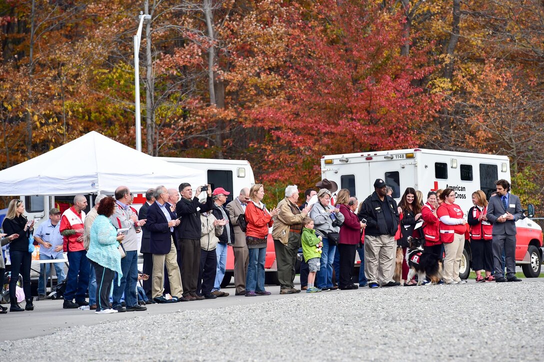 Attendees of the second annual Feel the Heat event, held here Oct. 22, 2015, watch as the 910th Civil Engineer Squadron Fire Department responds to a blaze on a mock training aircraft. Feel the Heat is an interactive training and demonstration event involving the 910th Airlift Wing and the American Red Cross Lake to River Chapter.  (U.S. Air Force photo/Eric M. White)