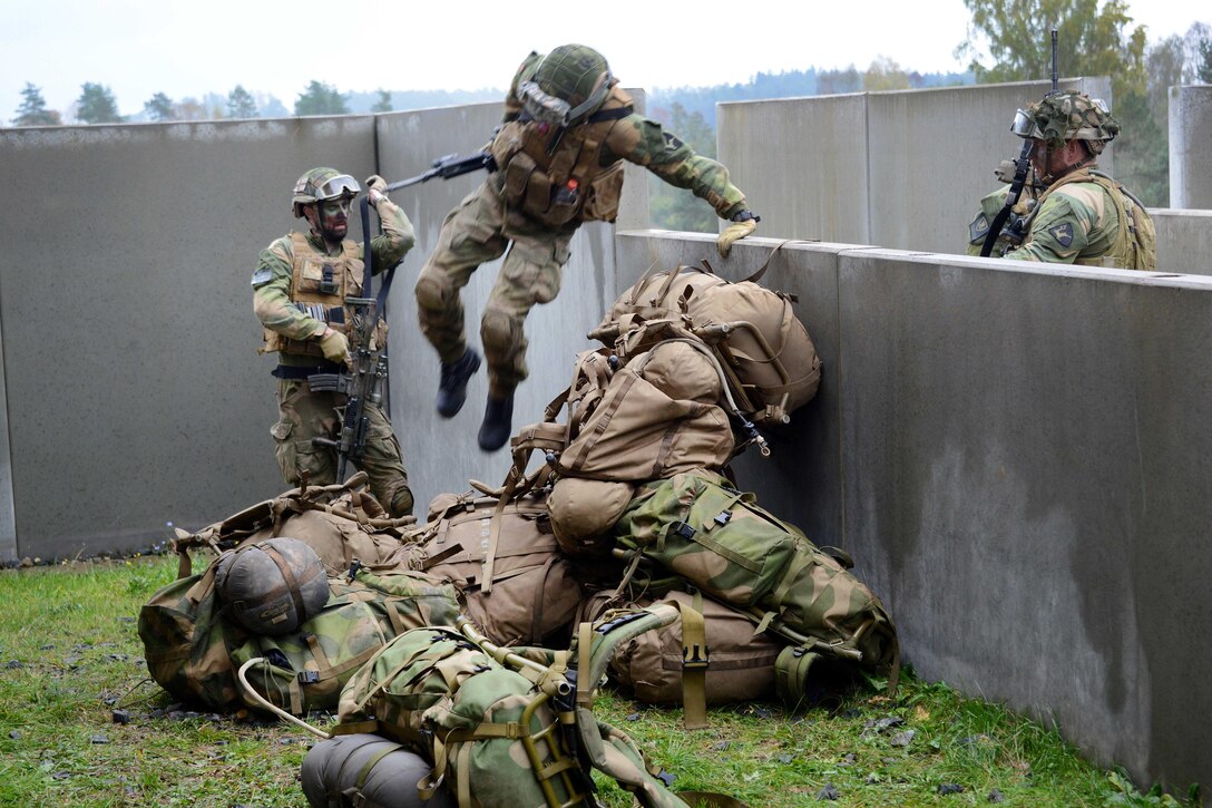 Norwegian soldiers engage the urban casualty evacuation lane during the European Best Squad Competition at the Grafenwoehr Training Area in Bavaria, Germany, Oct. 20, 2015. U.S. Army photo by Gertrud Zach