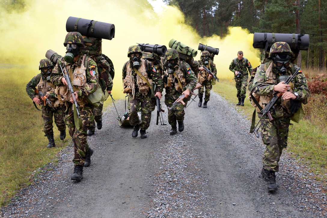 Romanian army soldiers transport a mannequin during biological and nuclear task lane part of the European Best Squad Competition at the Grafenwoehr Training Area in Bavaria, Germany, Oct. 20, 2015. U.S. Army photo by Gertrud Zach
