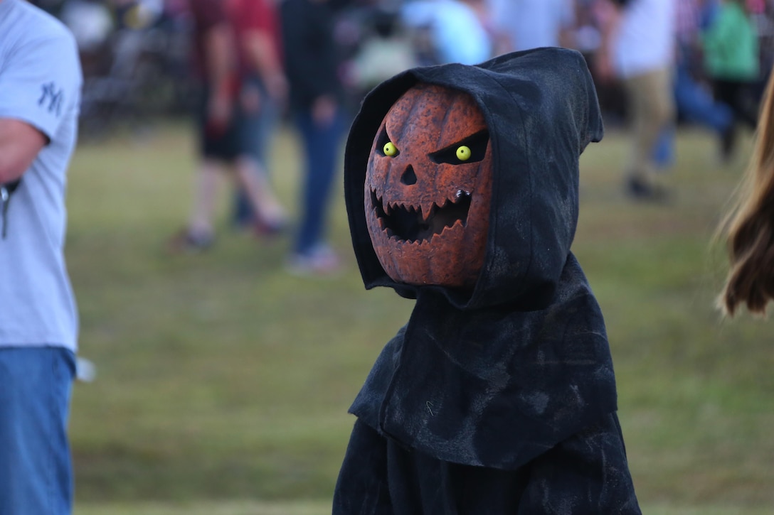 A child dressed as a pumpkin king stands waiting to have his costume judged during a costume contest at the Fall Family Festival hosted by Marine Air Control Squadron 2 at Marine Corps Air Station Cherry Point, N.C., Oct. 22, 2015.  More than 100 Marines, Sailors and family members gathered to kick off the fall season with a chili cook-off and costume contest as well as games, a movie and a bonfire. (U.S. Marine Corps photo by Cpl. N.W. Huertas/Released)