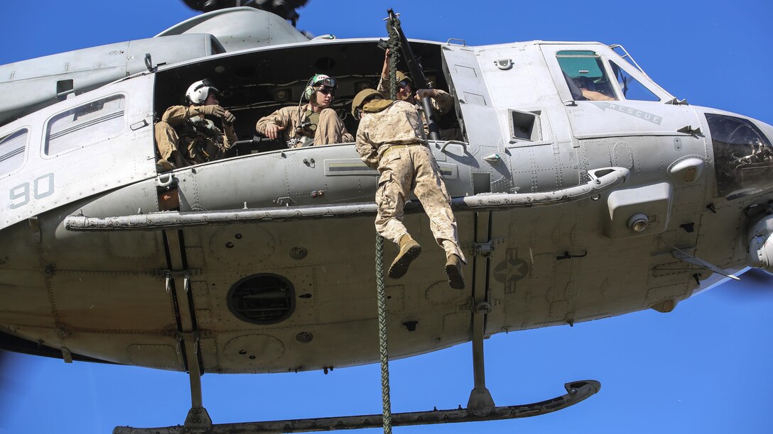 A Marine student with the Expeditionary Operations Training Group conducts a fast-rope descent out of an UH-1Y Venom helicopter as part of the Helicopter Rope Suspension Techniques Master Course at Marine Corps Base Camp Lejeune, N.C., Oct. 21, 2015. The Marines conducted their descent at approximately 50 feet from the helicopter, which was operated by pilots with Marine Light Attack Helicopter Squadron 167. 