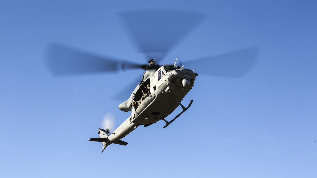 A UH-1Y Venom helicopter, operated by pilots with Marine Light Attack Helicopter Squadron 167, makes a pass over Landing Zone Bluebird during the Helicopter Rope Suspension Techniques Master Course at Marine Corps Base Camp Camp Lejeune, N.C., Oct. 21, 2015. The course, conducted by the Expeditionary Operations Training Group, focused on mastering fast-rope and rappelling techniques form aircraft. 