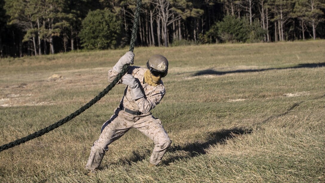 A Marine student with the Expeditionary Operations Training Group touches ground after fast-roping out of a UH-1Y Venom helicopter as part of the Helicopter Rope Suspension Techniques Master Course at Marine Corps Base Camp Camp Lejeune, N.C., Oct. 21, 2015. The Marines conducted their descent at approximately 50 feet from the helicopter, which was operated by pilots with Marine Light Attack Helicopter Squadron 167. 