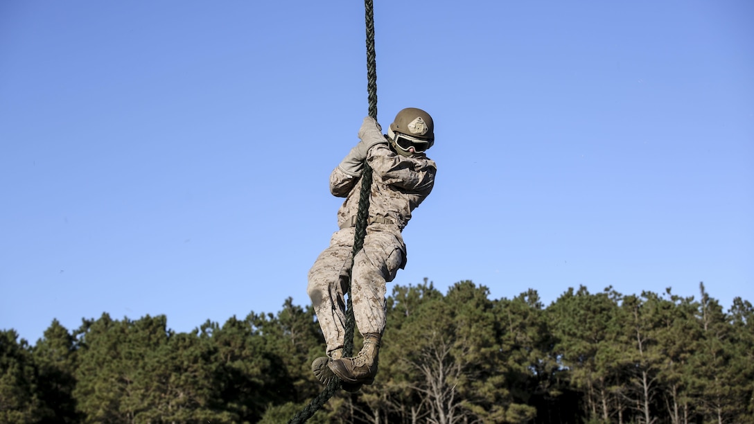 A Marine student with the Expeditionary Operations Training Group conducts a fast-rope descent out of an UH-1Y Venom helicopter as part of the Helicopter Rope Suspension Techniques Master Course at Marine Corps Base Camp Lejeune, N.C., Oct. 21, 2015. The Marines conducted their descent at approximately 50 feet from the helicopter, which was operated by pilots with Marine Light Attack Helicopter Squadron 167. 