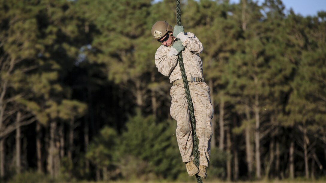 A Marine student with the Expeditionary Operations Training Group conducts a fast-rope descent out of an UH-1Y Venom helicopter as part of the Helicopter Rope Suspension Techniques Master Course at Marine Corps Base Camp Lejeune, N.C., Oct. 21, 2015. The Marines conducted their descent at approximately 50 feet from the helicopter, which was operated by pilots with Marine Light Attack Helicopter Squadron 167. 