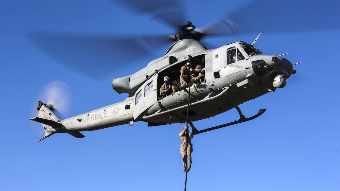 A Marine student with the Expeditionary Operations Training Group conducts a fast-rope descent out of an UH-1Y Venom helicopter as part of the Helicopter Rope Suspension Techniques Master Course at Marine Corps Base Camp Lejeune, N.C., Oct. 21, 2015. The Marines conducted their descent at approximately 50 feet from the helicopter, which was operated pilots with by Marine Light Attack Helicopter Squadron 167. 
