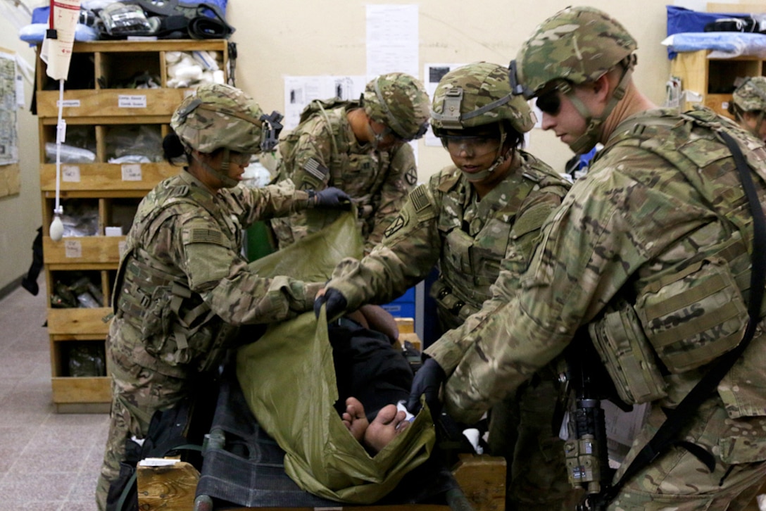 U.S. soldiers provide medical aid to a simulated patient during a mass casualty exercise on Tactical Base Gamberi, Laghman province, Afghanistan, Oct. 17, 2015. U.S. Army photo by Maj. Asha Cooper