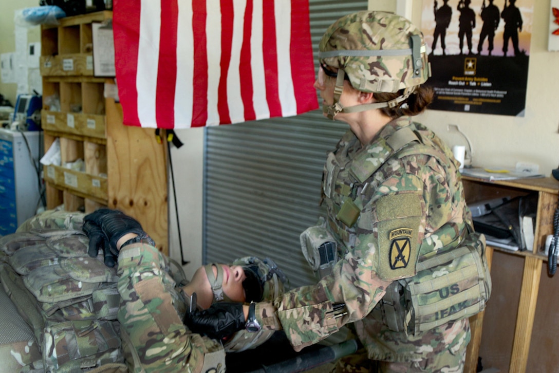 A U.S. soldier provides medical aid to a simulated patient during a mass casualty exercise on Tactical Base Gamberi, Laghman province, Afghanistan, Oct. 17, 2015. U.S. Army photo by Maj. Asha Cooper