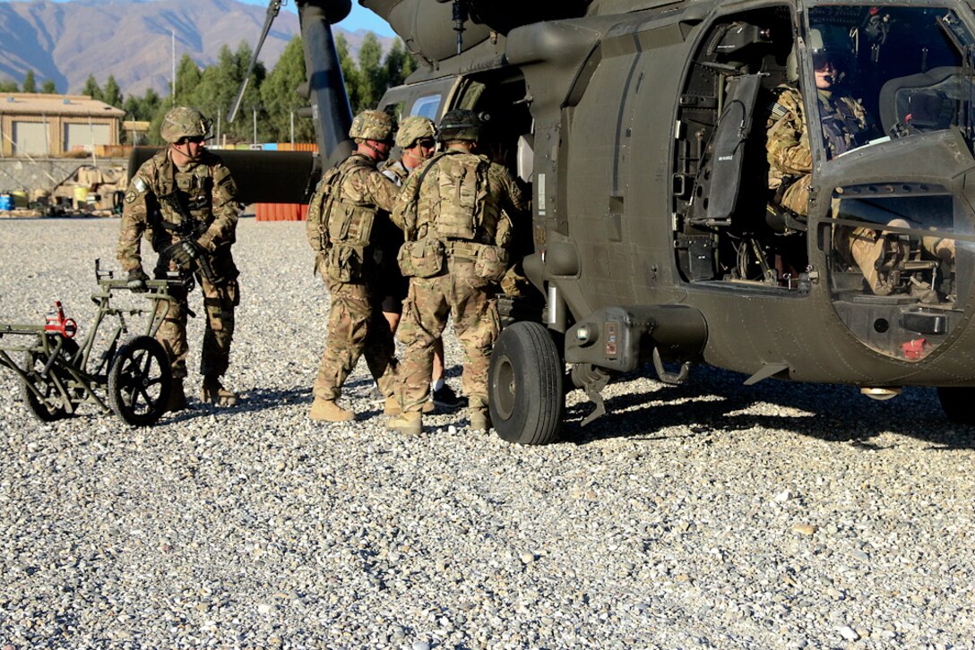 U.S. soldiers load a simulated patient into a UH-60 Black Hawk medevac helicopter during a mass casualty exercise on Tactical Base Gamberi, Laghman province, Afghanistan, Oct. 17, 2015. U.S. Army photo by Maj. Asha Cooper