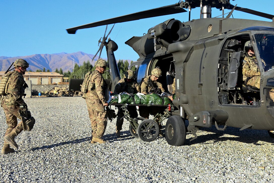 U.S. soldiers load a simulated patient onto a UH-60 Black Hawk medevac helicopter during a mass casualty exercise on Tactical Base Gamberi, Laghman province, Afghanistan, Oct. 17, 2015. U.S. Army photo by Maj. Asha Cooper