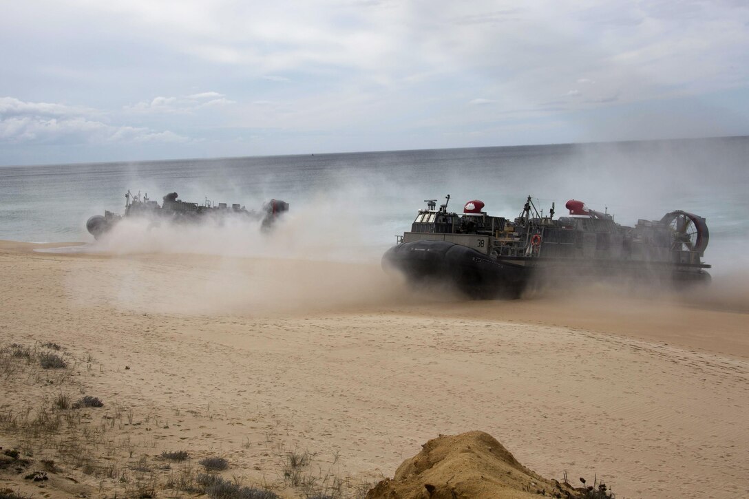 U.S. and Portuguese Marines in Landing Craft air cushions from the USS Arlington and USS Kearsarge Amphibious Ready Group move towards Pinheiro Da Cruz Beach, Portugal, Oct. 20, 2015. The Marines participated in a combined amphibious assault exercise during Trident Juncture 15. U.S. Marine Corps photo by Cpl Jeraco Jenkins  