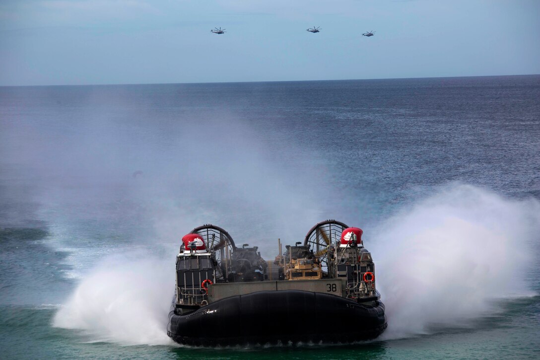 U.S. and Portuguese Marines in Landing craft air cushions from the USS Arlington, Kearsarge Amphibious Ready Group move towards Pinheiro Da Cruz Beach, Portugal, Oct. 20, 2015. Marines participated in a combined amphibious assault exercise during Trident Juncture 15. U.S. Marine Corps photo by Cpl Jeraco Jenkins