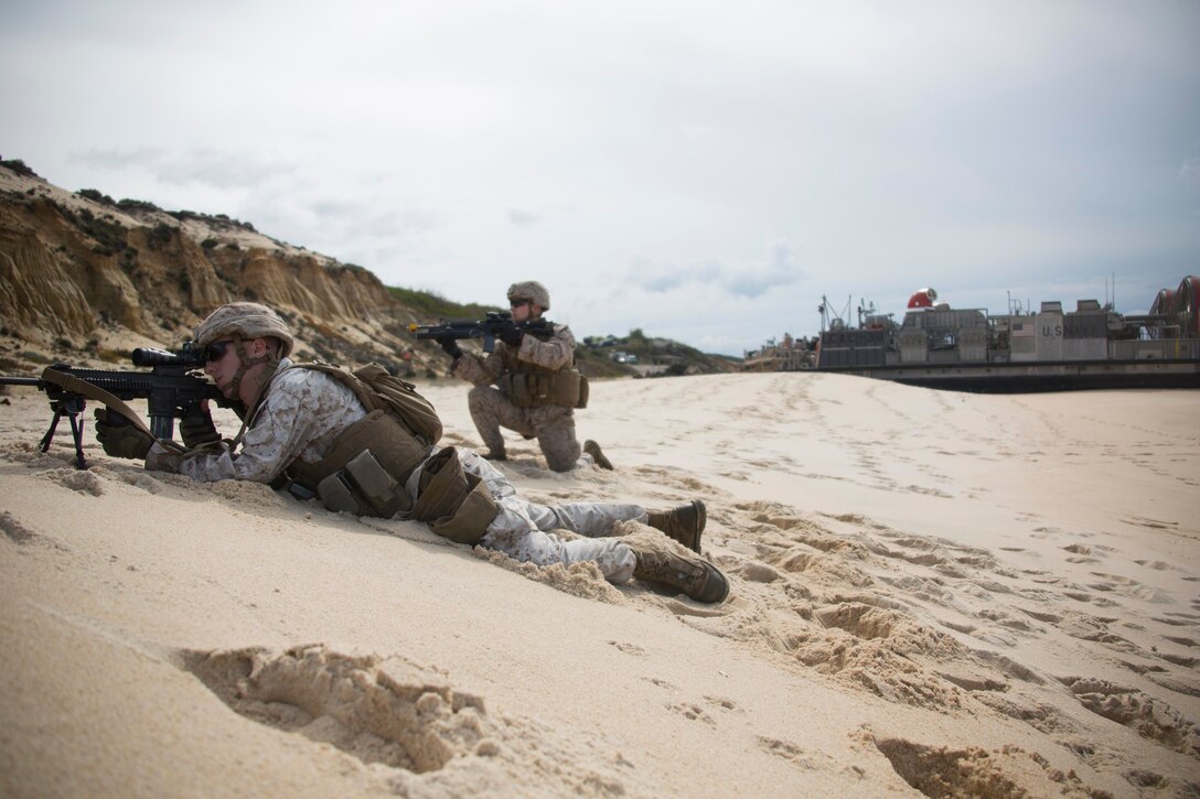 U.S. and Portuguese Marines provide security for a Landing Craft Air Cushion on Pinheiro Da Cruz Beach, Portugal, Oct. 20, 2015, during Trident Juncture 15. U.S. Marine Corps photo by Cpl Jeraco Jenkins