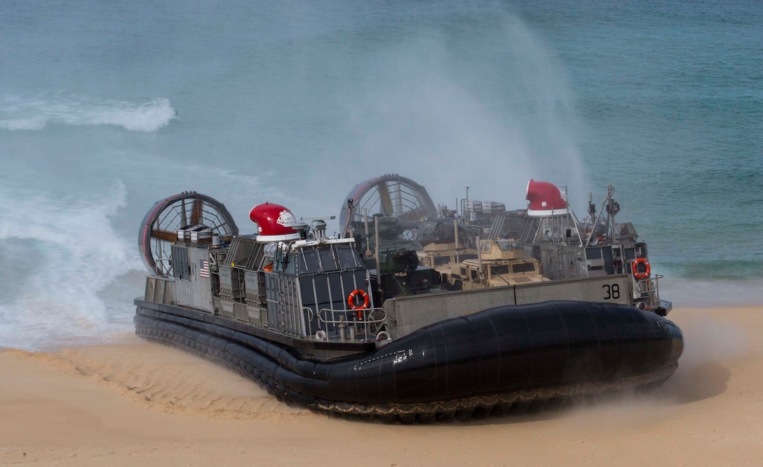 U.S. and Portuguese Marines in Landing craft air cushions from the USS Arlington, Kearsarge Amphibious Ready Group move towards Pinheiro Da Cruz Beach, Portugal, Oct. 20, 2015, to participate in a combined amphibious assault exercised during Trident Juncture 15. U.S. Marine Corps photo by Sgt. Austin Long
