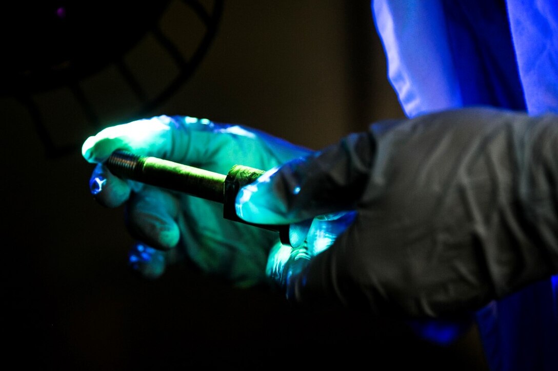 GULF OF OMAN (Oct. 25, 2015) U.S. Marine Sgt. Taylor Harris inspects an M240B machine gun bolt stud aboard the amphibious assault ship USS Essex (LHD 2). Harris is a non-destructive inspection technician with Medium Marine Tiltrotor Squadron 161 (Reinforced), 15th Marine Expeditionary Unit. She inspected the bolt for any cracks or discrepancies to ensure the M240 functions properly. The 15th MEU, embarked on the ships of the Essex Amphibious Ready Group, is deployed to maintain regional security in the U.S. 5th Fleet area of operations. (U.S. Marine Corps photo by Sgt. Anna Albrecht/Released)
