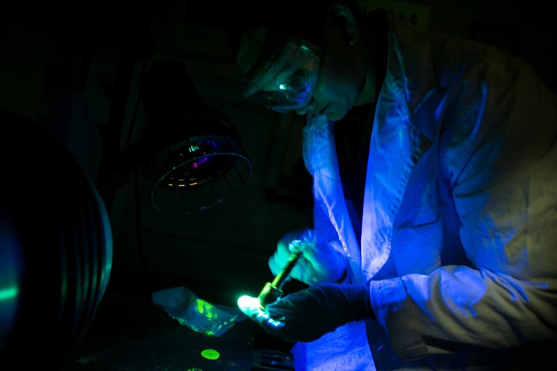 GULF OF OMAN (Oct. 25, 2015) U.S. Marine Sgt. Taylor Harris inspects an M240B machine gun bolt stud aboard the amphibious assault ship USS Essex (LHD 2). Harris is a non-destructive inspection technician with Medium Marine Tiltrotor Squadron 161 (Reinforced), 15th Marine Expeditionary Unit. She inspected the bolt for any cracks or discrepancies to ensure the M240 functions properly. The 15th MEU, embarked on the ships of the Essex Amphibious Ready Group, is deployed to maintain regional security in the U.S. 5th Fleet area of operations. (U.S. Marine Corps photo by Sgt. Anna Albrecht/Released)