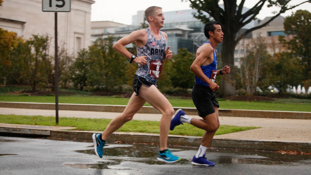Oscar Mateo Santos, right, and Trevor Lafontaine run through the National Mall in Washington, D.C., Oct. 25, 2015, during the 40th Marine Corps Marathon. Lafontaine finished in first place with a winning time of 2:24.25, followed by Santos with a time of 2:26.08. U.S. Marine Corps photo by Sgt. Terence Brady