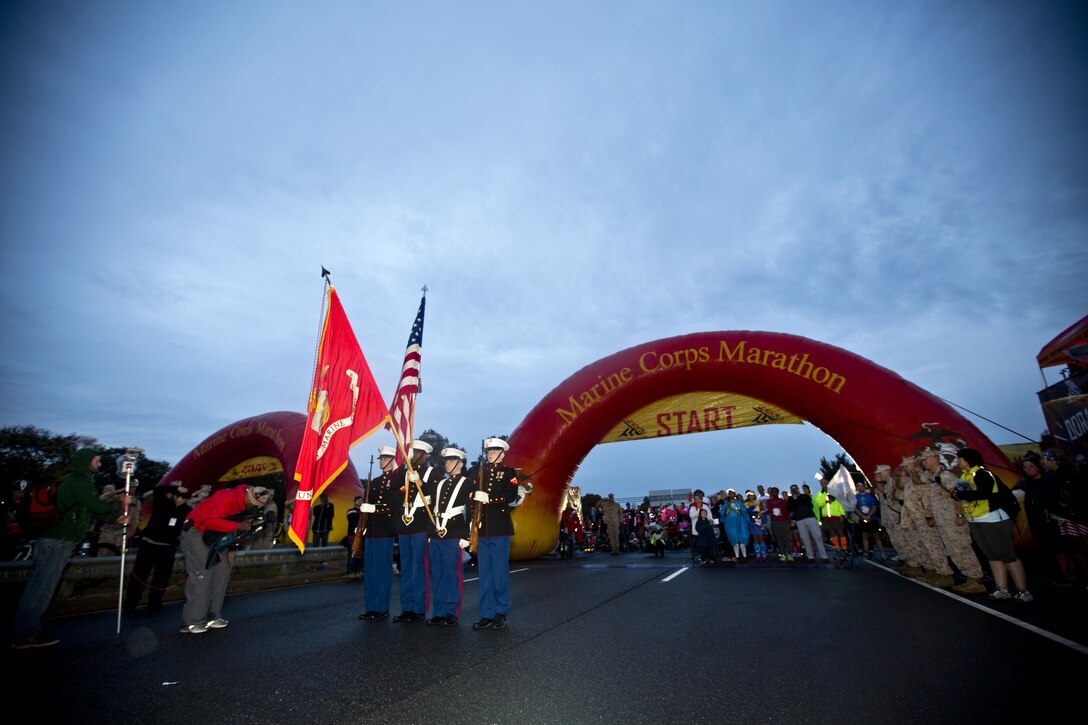 Marines present the American and Marine Corps flag before the Marine Corps Marathon in Arlington, Va., Oct. 25, 2015. U.S. Marine Corps photo by Sgt. Gabriela Garcia