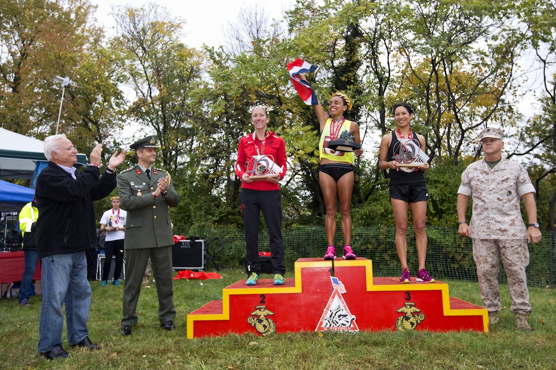 Marine Corps Commandant Gen. Robert B. Neller, right, poses for a photograph with the top three women finishers of the Marine Corps Marathon in Arlington, Va., Oct. 25, 2015. U.S. Marine Corps photo by Sgt. Gabriela Garcia