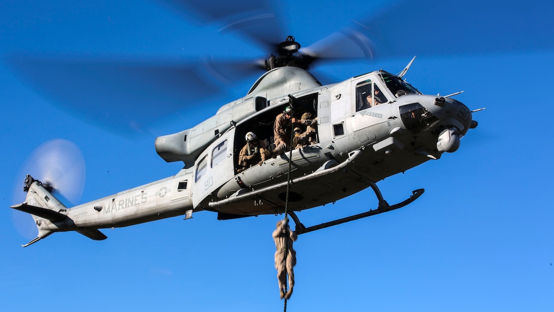 A Marine student with the Expeditionary Operations Training Group conducts a fast-rope descent out of an UH-1Y Venom helicopter as part of the Helicopter Rope Suspension Techniques Master Course at Camp Lejeune, N.C., Oct. 21, 2015. The Marines conducted their descent at approximately 50 feet from the helicopter, which was operated pilots with by Marine Light Attack Helicopter Squadron 167. (U.S. Marine Corps photo by Cpl. Paul S. Martinez/Released)