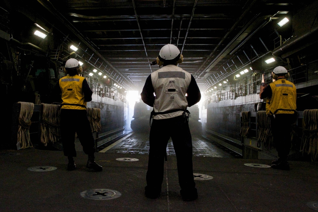 Boatswain’s 2nd Class Adrienne Jones, Chief Boatswain’s Mate Ernesto Herrera, and Boatswain’s Mate 2nd Class Phillip Gers watch as a landing craft air cushion departs from the well deck of the amphibious transport dock ship USS New Orleans, off the coast of Southern Calif., Oct 21, 2015. The New Orleans is part of the Boxer Amphibious Ready Group, which is currently completing a Composite Training Exercise with the amphibious assault ship USS Boxer the amphibious dock landing ship USS Harpers Ferry, and the 13th Marine Expeditionary Unit, to test their abilities to effectively respond to scenario driven events and perform as an integrated unit in preparation for deployment. U.S. Navy photo by Mass Communication Specialist Seaman Chelsea D. Daily