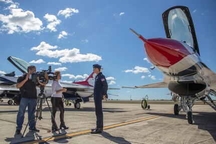 Maj. Alexander Goldfein, U.S. Air Force Aerial Demonstration Squadron pilot, is interviewed by Delaine Mathieu, WOAI News 4 San Antonio, prior to the opening of the 2015 Joint Base San Antonio Air Show and Open House Oct. 26, 2015 at JBSA-Randolph.  Air shows are an important recruiting tool for the Air Force, and an opportunity for the Air Force to offer a glimpse into some of the Air Force jobs available.  Events like this also showcase today’s Air Force equipment and technology being used.
