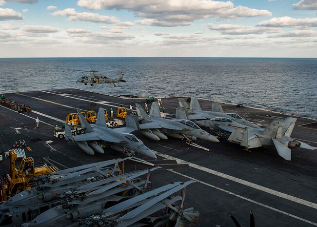 WATERS TO THE EAST OF THE KOREAN PENINSULA (Oct. 26, 2015) - An MH-60S Seahawk from the "Golden Falcons" of Helicopter Sea Combat Squadron (HSC) 12 during a replenishment-at-sea between the U.S. Navy's only forward-deployed aircraft carrier USS Ronald Reagan (CVN 76) and Military Sealift Command fleet replenishment oiler USNS Tippecanoe (T-AO 199). Ronald Reagan, and its embarked carrier air wing, Carrier Air Wing (CVW) 5, provide a combat-ready force that protects the collective maritime interests of its allies and partners in the Indo-Asia-Pacific Region. 