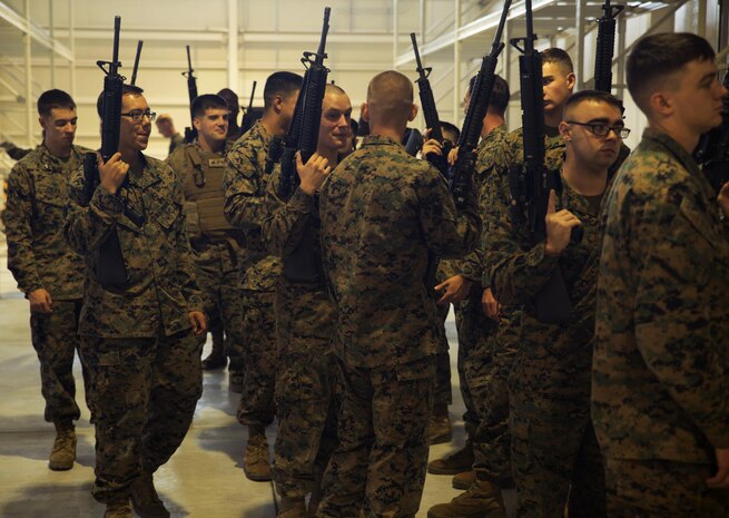 Marines congregate after receiving their issued rifles during Strategic Mobility Exercise 16 at Marine Corps Air Station Iwakuni, Japan, Oct. 19-23, 2015. STRATMOBEX tests the ability of the Marines and their units to deploy to an area in need of assistance in a timely manner.