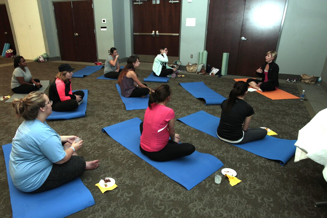 Spouses of active-duty service members participate in relaxation techniques during the annual Spouses Spa Day hosted by Marine Corps Family Team Building at Marine Corps Air Station Cherry Point, N.C., Oct. 22, 2015. During the event spouses of active-duty service members were pampered with facials, foot soaks and were given strategies to help them relax. Spouses enjoyed free yoga, fresh smoothies and mini spa treatments. MCFTB used the event as an opportunity to give the ladies a relaxing experience to combat the stresses of being a military spouse. (U.S. Marine Corps photo by Lance Cpl. Jason Jimenez/Released)
