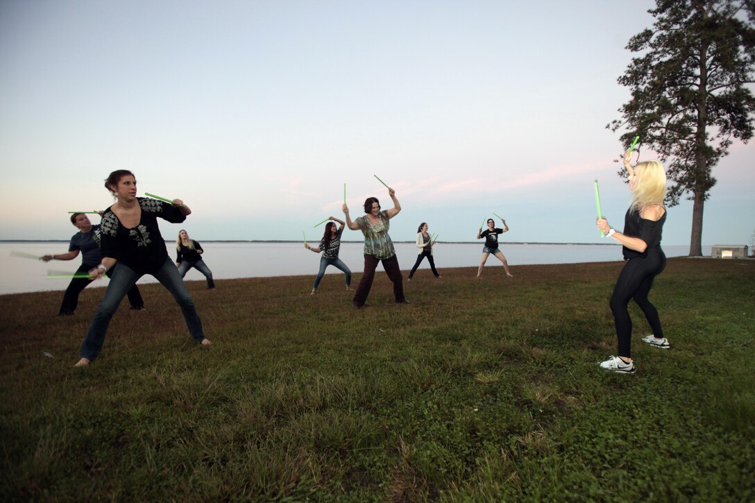 Spouses of active-duty service members participate in Pound, an aerobic workout during the annual Spouses Spa Day hosted by Marine Corps Family Team Building at Marine Corps Air Station Cherry Point, N.C., Oct. 22, 2015. During the event spouses of active-duty service members were pampered with facials, foot soaks and were given strategies to help them relax. Spouses enjoyed free yoga, fresh smoothies and mini spa treatments. MCFTB used the event as an opportunity to give the ladies a relaxing experience to combat the stresses of being a military spouse. (U.S. Marine Corps photo by Lance Cpl. Jason Jimenez/Released)