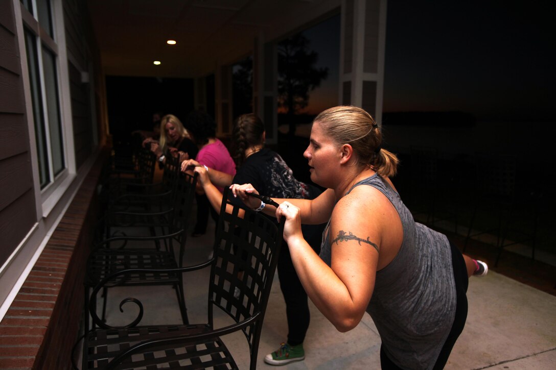 Spouses of active-duty service members participate in ballet-related aerobic workouts during the annual Spouses Spa Day hosted by Marine Corps Family Team Building at Marine Corps Air Station Cherry Point, N.C., Oct. 22, 2015. During the event spouses of active-duty service members were pampered with facials, foot soaks and were given strategies to help them relax. Spouses enjoyed free yoga, fresh smoothies and mini spa treatments. MCFTB used the event as an opportunity to give the ladies a relaxing experience to combat the stresses of being a military spouse. (U.S. Marine Corps photo by Lance Cpl. Jason Jimenez/Released)