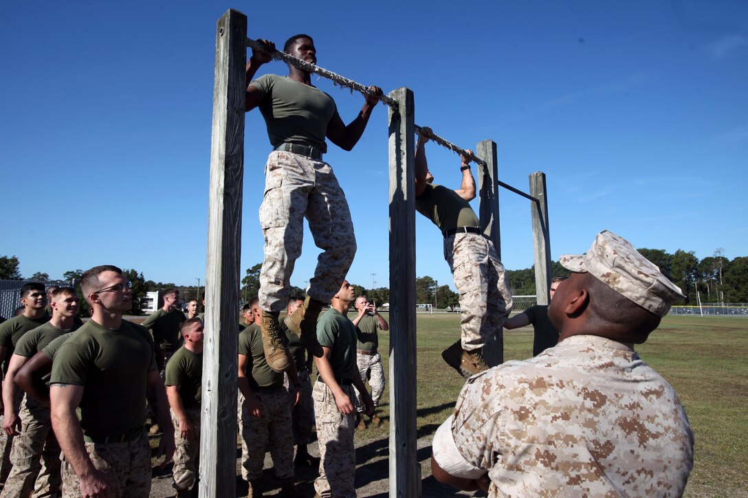 Marines execute pull ups during the semi-annual field meet between Headquarters and Headquarters Squadron and Marine Wing Headquarters Squadron 2 at Marine Corps Air Station Cherry Point, N.C., Oct. 23, 2015. Marines with H&HS and MWHS-2 went head-to-head in a tug-of-war, a 7-ton pull, relay races and other events to build teamwork and camaraderie. (U.S. Marine Corps photo by Lance Cpl. Jason Jimenez/Released)