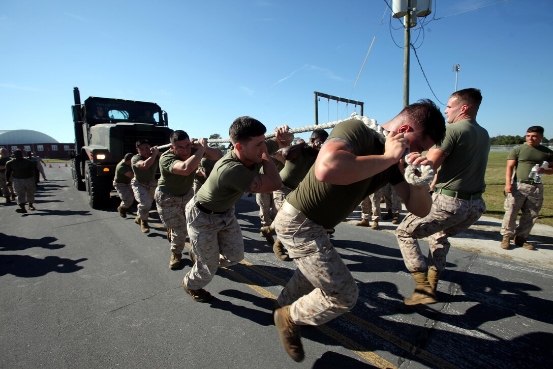 Marines pull a 7-ton truck during the semi-annual field meet between Headquarters and Headquarters Squadron and Marine Wing Headquarters Squadron 2 at Marine Corps Air Station Cherry Point, N.C., Oct. 23, 2015. Marines with H&HS and MWHS-2 went head-to-head in a tug-of-war, a 7-ton pull, relay races and other events to build teamwork and camaraderie. (U.S. Marine Corps photo by Lance Cpl. Jason Jimenez/Released)
