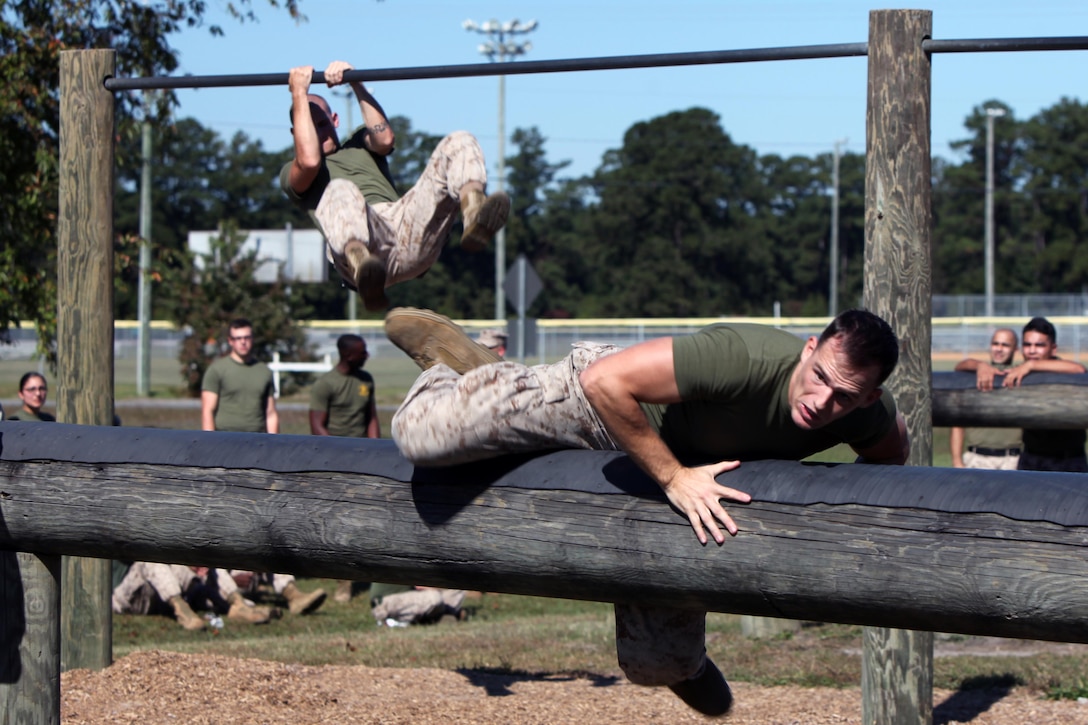 Cpl. Scott Maynard negotiates an elevated log while completing the course obstacle during the semi-annual field meet between Headquarters and Headquarters Squadron and Marine Wing Headquarters Squadron 2 at Marine Corps Air Station Cherry Point, N.C., Oct. 23, 2015. Marines with H&HS and MWHS-2 went head-to-head in a tug-of-war, a 7-ton pull, relay races and other events to build teamwork and camaraderie. Maynard is a food service specialist with H&HS. (U.S. Marine Corps photo by Lance Cpl. Jason Jimenez/Released)