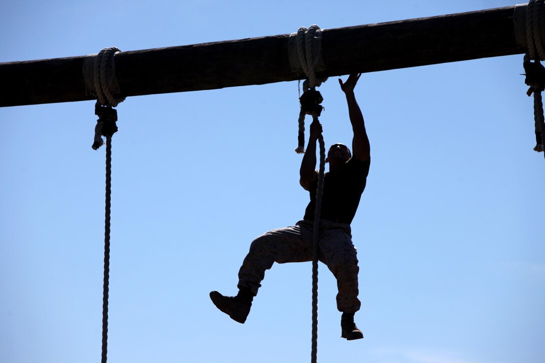 Sgt. Amado Benin II completes a rope climb during the semi-annual field meet between Headquarters and Headquarters Squadron and Marine Wing Headquarters Squadron 2 at Marine Corps Air Station Cherry Point, N.C., Oct. 23, 2015. Marines with H&HS and MWHS-2 went head-to-head in a tug-of-war, a 7-ton pull, relay races and other events to build teamwork and camaraderie. Benin is an imagery analysis specialist with MWHS-2. (U.S. Marine Corps photo by Lance Cpl. Jason Jimenez/Released)