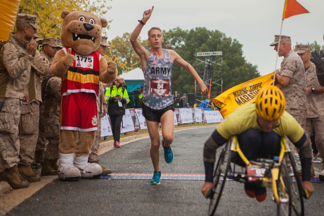 Trevor LaFontaine completes the 40th Marine Corps Marathon as the top male finisher in Arlington, Va., Oct. 25, 2015. Jenny Mendez Suanca was the first female to finish. U.S. Marine Corps photo by Sgt. Justin Boling