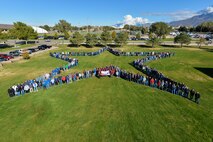 Employees from the 309th Electronics Maintenance Group form a star in Hill Air Force Base's Centennial Park in recognition of their achieving Star status in the Voluntary Protection Program. The group was honored Oct. 20 by representatives from the U.S. Department of Labor, the Undersecretary of Defense and the American Federation of Government Employees Local 1592. (U.S. Air Force photo by R. Nial Bradshaw)
