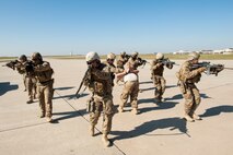 Members of the 791st Missile Security Forces Squadron tactical response force form up around their apprehended suspect during a training exercise at Minot Air Force Base, N.D., Oct. 8, 2015. During the training exercise members approached and apprehended a suspect and their vehicle to eliminate any threat. (U.S. Air Force photo/Airman 1st Class Christian Sullivan)