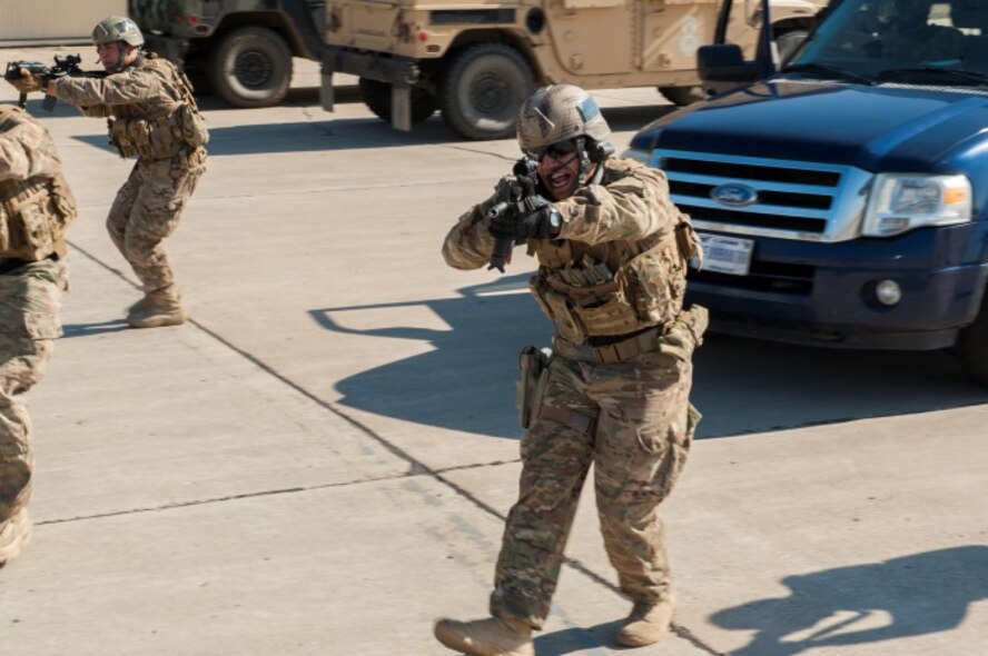 Senior Airman Luis Colon, 791st Missile Security Forces Squadron tactical response force assaulter, yells as he approaches a suspect during a training exercise at Minot Air Force Base, N.D., Oct. 8, 2015.  TRF is a nuclear special weapons and tactics team specializing in recapture and recovery operations. (U.S. Air Force photo/Airman 1st Class Christian Sullivan)