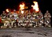 Base firefighters, commanders and chiefs pose for a photo during a controlled fire demonstration Oct. 22, 2015, at Fairchild Air Force Base, Wash. Base leadership participated in a live fire demonstration on the flightline to learn how to help fight fires and experience what it is like to be a firefighter. They donned the gear and learned how to correctly use the air tanks and fire hoses. (U.S. Air Force photo/Airman 1st Class Taylor Bourgeous)