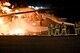 Firefighters assist base leadership in putting out a controlled fire during a demonstration Oct. 22, 2015, on the flightline at Fairchild Air Force Base, Wash. Commanders and chiefs participated in a live fire demonstration and learned what it takes to be a firefighter.  (U.S. Air Force photo/Airman 1st Class Taylor Bourgeous)