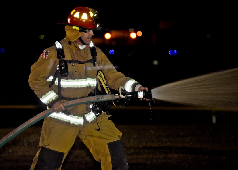 Chief Master Sgt. James Fitch, 92nd Operations Group superintendent, extinguishes a fire during a demonstration Oct. 22, 2015, on the flightline at Fairchild Air Force Base, Wash. Base commanders and chiefs were taught how to properly use equipment and were given a glimpse of what it takes to be a firefighter. (U.S. Air Force photo/Airman 1st Class Taylor Bourgeous)