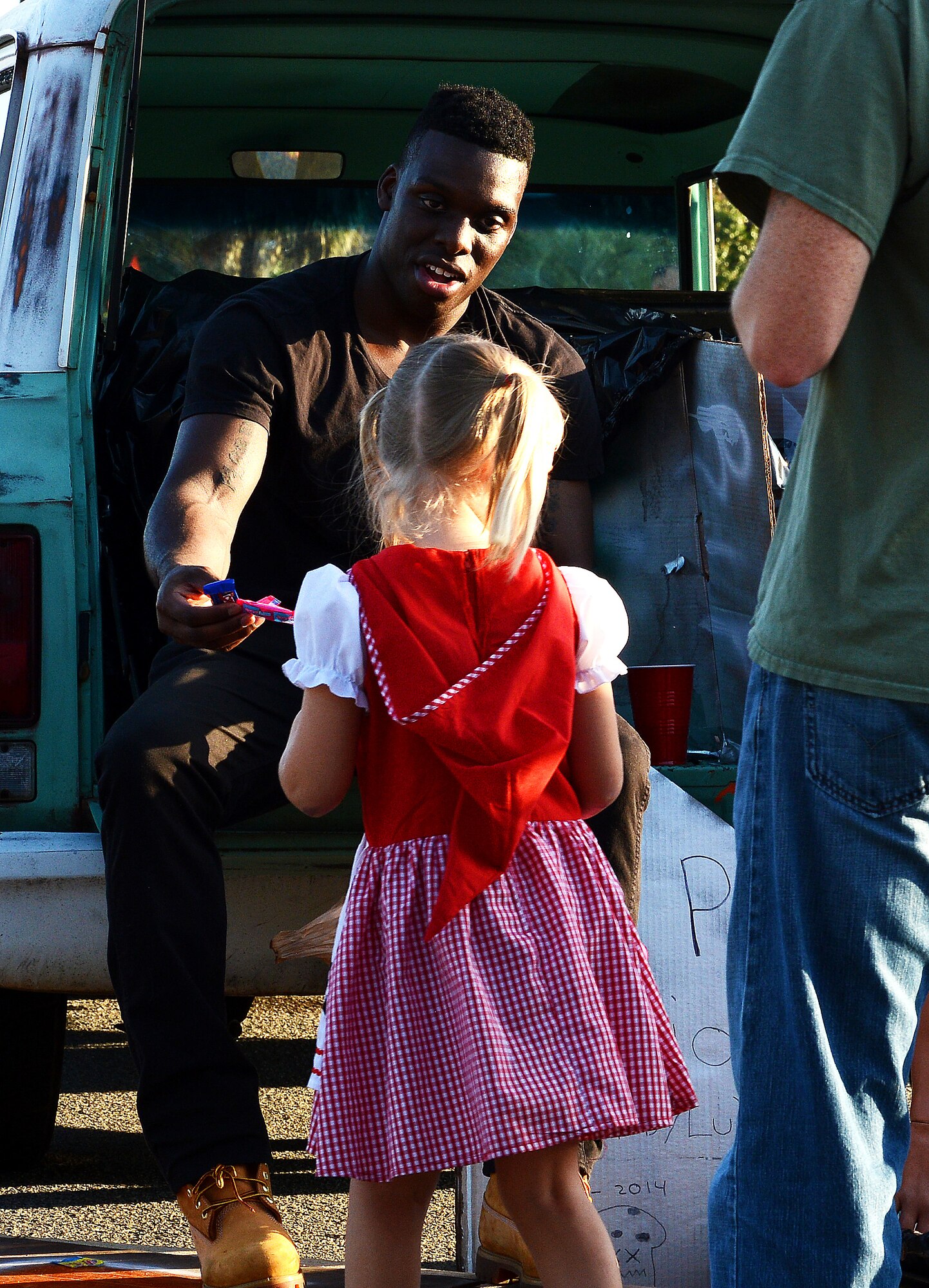 A Team Shaw member hands out candy to a trunk-or-treater during Boo Bash at Shaw Air Force Base, S.C., Oct. 24, 2015. Approximately 2,000 people attended the event, which was designed to provide a safe trick-or-treating experience. (U.S. Air Force photo by Senior Airman Jonathan Bass/Released)