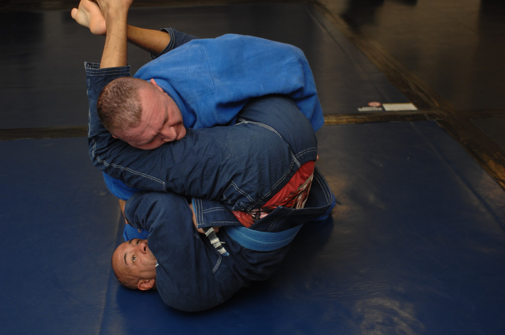 Leo Pavlushkin, 355th Security Force Squadron lead police officer, grapples with Garrett Clark, Air Force veteran and jiujitsu instructor during a Brazilian jiujitsu class at Davis-Monthan Air Force Base, Ariz., Sept. 30, 2015. The class is held Monday, Wednesday and Friday at 4:30 p.m. in the upstairs of the Airman Leadership School building 4455. (U.S. Air Force photo by Airman Basic Nathan H. Barbour/Released)