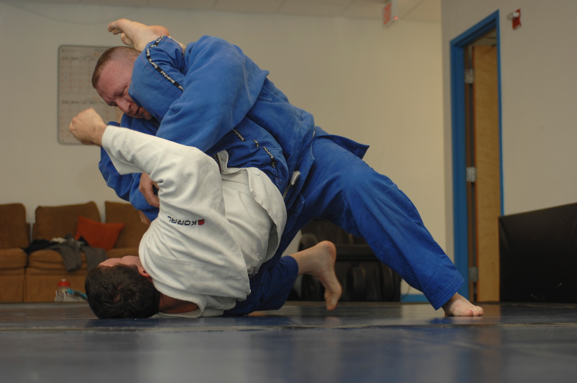 Leo Pavlushkin, 355th Security Forces Squadron lead police officer, grapples with Jariel Rivera, 355th Maintenance Group squadron lead crew member, during a Brazilian jiujitsu class at Davis-Monthan Air Force Base, Ariz., Sept. 30, 2015. The class is held Monday, Wednesday and Friday at 4:30 p.m. in the upstairs of the Airman Leadership School building 4455. (U.S. Air Force photo by Airman Basic Nathan H. Barbour/Released)