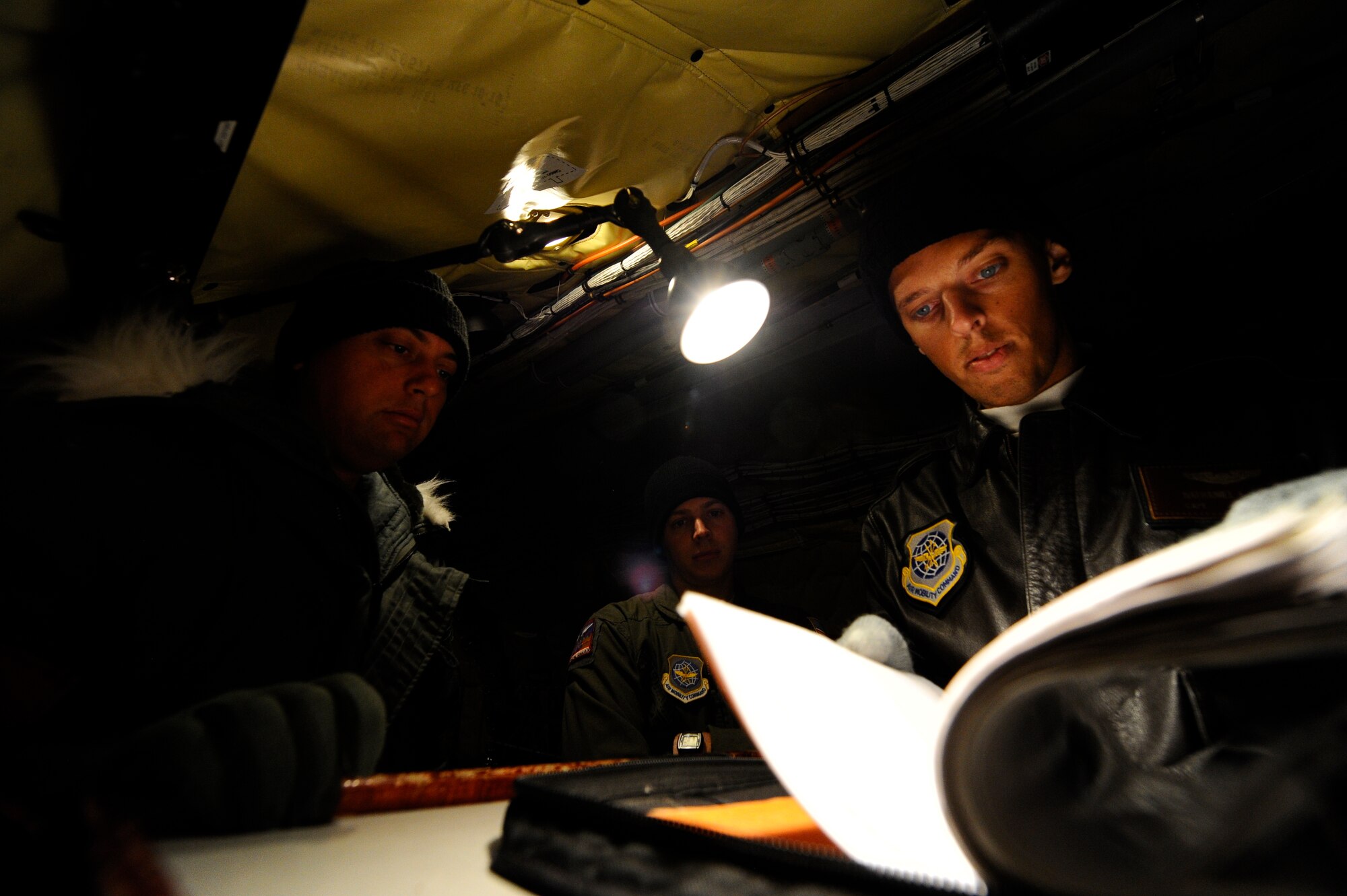Capt. Nathanial Beer, 384th Air Refueling Squadron pilot, right, goes over mission plans with Capt. Even Johnston, 384th ARS pilot, and Staff Sgt. Adam Clark, 384th ARS boom operator, before an aerial refueling sortie, Oct. 22, 2015, at 5 Wing Goose Bay, Canada. From Oct. 15 - 26, 2015, approximately 700 members from the Canadian Armed Forces, United States Air Force, United States Navy, and United States Air National Guard are deploying to Iqaluit, Nunavut, and 5 Wing Goose Bay, Newfoundland and Labrador for Exercise Vigilant Shield 16 (U.S. Air Force photo by Senior Airman Victor J. Caputo)