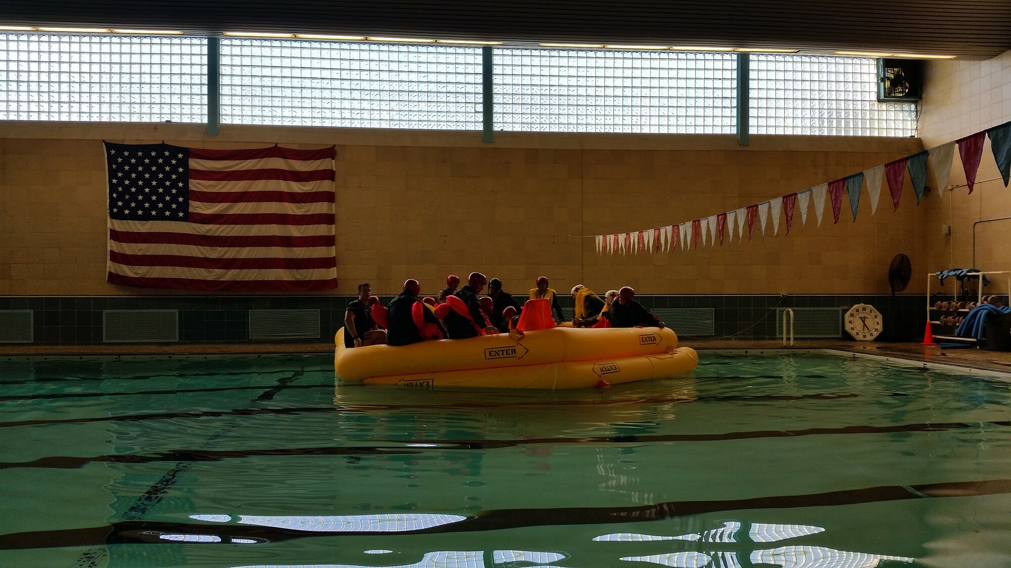WRIGHT-PATTERSON AIR FORCE BASE, Ohio – Airmen assigned to the 89th Airlift Squadron and 445th Operations Support Squadron hone their water survival skills during a training scenario at the Dodge Gym here Oct. 4, 2015. During the semi-annual training, the Airmen were able to board a 25-man life raft and have the instructors from the 445th OSS aircrew flight equipment shop show them the different survival supplies that they can expect to find on a raft. While on the raft, the Airmen learned about raft care and maintenance, food and water procurement, first aid, protecting oneself from the outside elements, and signaling for help. (U.S. Air Force photo/Staff Sgt. Steven Sandmann)