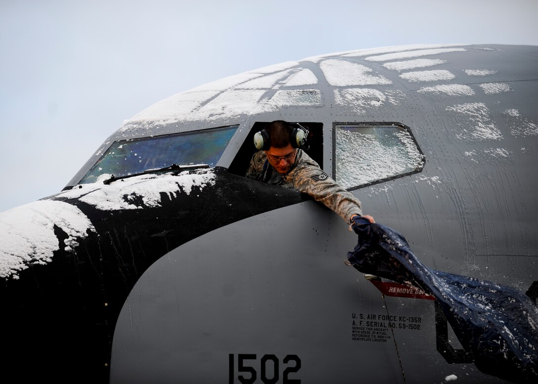 A U.S. Air Force staff sergeant shakes the snow off the window cover of a KC-135 Stratotanker, Oct. 19, 2015, at 5 Wing Goose Bay, Canada. From Oct. 15 - 26, 2015, approximately 700 members from the Canadian Armed Forces, United States Air Force, United States Navy, and United States Air National Guard are deploying to Iqaluit, Nunavut, and 5 Wing Goose Bay, Newfoundland and Labrador for Exercise Vigilant Shield 16. (U.S. Air Force photo by Senior Airman Victor J. Caputo)